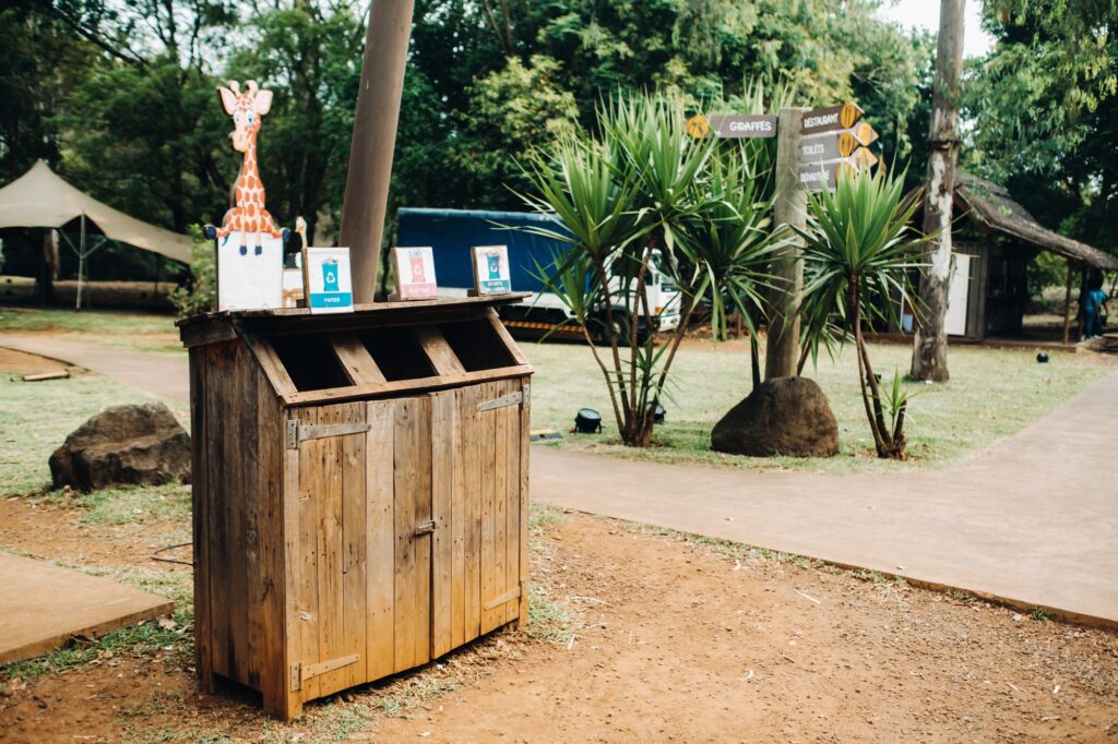 Wooden trash can for collecting separately plastic, cardboard and organic products in a Park on the
